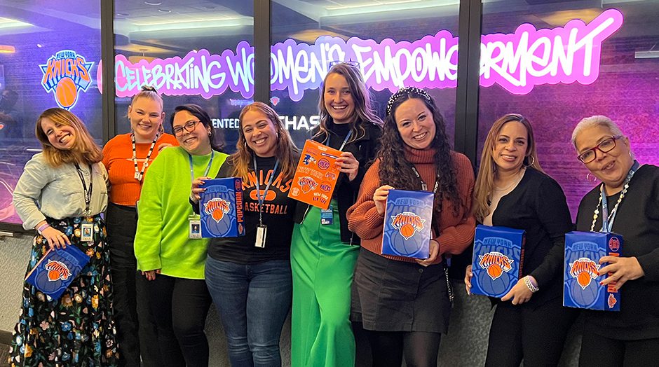 Sphere Entertainment Co employees posing for photo with New York Knicks memorabilia