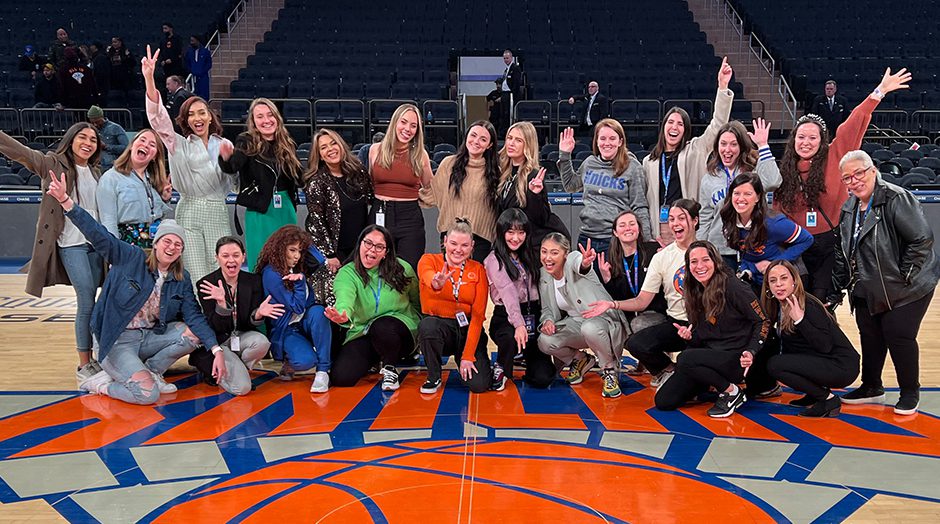 Sphere Entertainment Co employees posing for photo on New York Knicks court